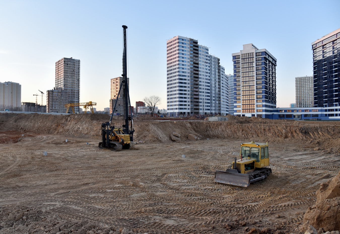 Tracked,Pile-driver,And,Bulldozer,At,Construction,Site,On,Sunset.,Piles